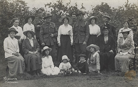 Two Australian soldiers posse with a group